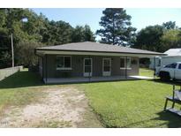 Charming single-story home featuring a well-maintained lawn, covered porch, and neutral-toned exterior at 216 Clayton St, Rocky Mount, NC 27803