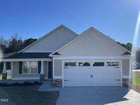 Charming single-story home featuring a two-car garage, neutral siding, and manicured lawn at 24 Heatherglenn Cir, Princeton, NC 27569