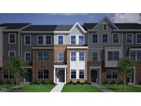 Charming three-story townhome with brick facade, light grey accents, and inviting front entrances at 324 Chesapeak Commons St # 143, Garner, NC 27529
