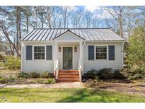 Charming home features a metal roof, painted brick stairs, and beautiful landscaping at 35 Rogerson Dr, Chapel Hill, NC 27517