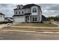 Charming two-story home with attached garage and manicured lawn at 4302 Emeline Way # 16, Fuquay Varina, NC 27526