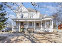 Charming two-story home featuring a classic wrap-around porch and decorative architectural details at 616 N Mebane St, Burlington, NC 27217
