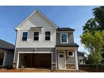Charming two-story home featuring a modern design, a spacious garage, and a beautifully landscaped yard at 82 Fairwinds Dr, Lillington, NC 27546