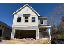 New two-story home featuring an attached two-car garage and gray wood siding at 82 Fairwinds Dr, Lillington, NC 27546