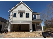 New construction home with modern design, light gray exterior, and an attached two-car garage at 82 Fairwinds Dr, Lillington, NC 27546