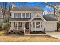 Charming two-story home featuring a welcoming front porch and attached garage at 106 Ferris Wheel Ct, Cary, NC 27513