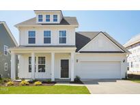 Charming new construction two-story home featuring a covered entryway and attached two car garage at 106 Willow Cameron Way, Angier, NC 27501