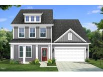 Charming two-story gray home with a two-car garage, red door and neatly manicured landscaping at 106 Willow Cameron Way, Angier, NC 27501