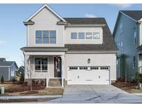 Charming two-story home with a two-car garage, covered porch, and meticulous landscaping at 1245 Barreto Dr, Wendell, NC 27591