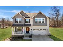 Charming two-story home with a welcoming front porch and a two-car garage at 1318 Reading Ct, Burlington, NC 27217