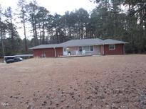 Charming ranch-style home with brick accents, front porch, and a spacious front yard, offering comfortable living at 2506 Poole Rd, Raleigh, NC 27610
