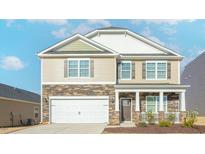 Charming two-story home featuring a stone and siding exterior with an attached two-car garage at 2561 Summersby Dr, Mebane, NC 27302