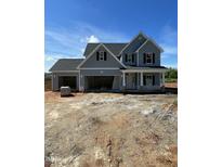 Two-story blue home with a three-car garage and black shutters, under construction at 432 E Clydes Point Way, Wendell, NC 27591