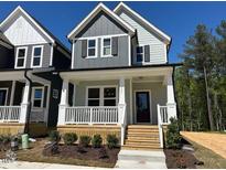 Charming two-story home featuring a welcoming front porch and modern architectural details at 500 Yeowell Dr, Chapel Hill, NC 27514