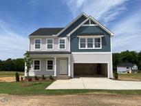 Charming two-story home with a two-car garage and a well-maintained lawn in a Gathering-friendly neighborhood at 108 Grove Township Way, Angier, NC 27501