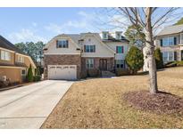 Charming two-story home with brick and siding, featuring a two-car garage and well-manicured lawn at 1137 Fanning Dr, Wake Forest, NC 27587