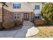 Inviting stone and siding exterior with a beautiful double door entrance and stone steps at 1137 Fanning Dr, Wake Forest, NC 27587
