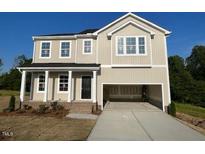 Charming two-story home with an attached two-car garage and inviting front porch at 119 Grove Township Way, Angier, NC 27501