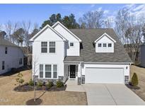 Charming two-story home with attached two-car garage, neutral paint, manicured lawn, and inviting front porch at 130 Silent Brook Trl, Franklinton, NC 27525