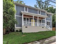 Charming two-story home with a welcoming front porch and yellow front door at 1521 Chapel Hill Rd, Durham, NC 27701