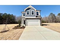 Charming two-story home featuring a two-car garage, gray siding and stone accents, and neatly landscaped front yard at 169 Steel Springs Lane Rd # 17, Angier, NC 27501