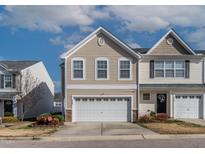 Inviting two-story home featuring a two-car garage and manicured landscaping at 1952 Grassy Banks Dr, Raleigh, NC 27610