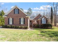 Charming brick home with manicured lawn, black shutters, and inviting entrance at 2030 Lonesome Dove Dr, Franklinton, NC 27525