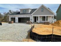 New construction home featuring a two-car garage and classic architectural details at 2328 Eagle Shot Ct # 18, Fuquay Varina, NC 27526