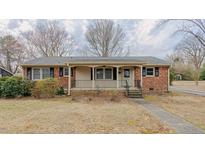 Charming brick home with a cozy front porch and well-maintained yard at 2720 Amherst Ave, Burlington, NC 27215