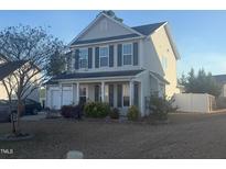 Charming two-story home with gray siding, black shutters, a front porch and a manicured lawn at 30 Boston Harbor Hbr, Cameron, NC 28326