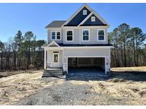 New construction two-story home with blue and gray siding and an attached two-car garage at 394 Duncan Creek Rd # 158, Lillington, NC 27546