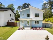 Charming two-story home showcasing a modern design and landscaped front yard with inviting curb appeal at 505 Colleton Rd, Raleigh, NC 27610