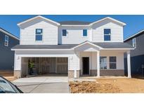 Newly constructed two-story home with an open garage and covered front porch at 547 White Birch Ln, Angier, NC 27501