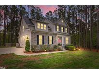 Charming two-story home with stone accents, well-lit landscaping, and an inviting front entrance at 749 Bowden Rd, Chapel Hill, NC 27516