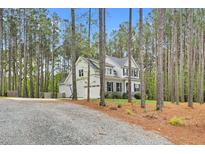 Charming two-story home with an attached garage is nestled in a wooded lot at 749 Bowden Rd, Chapel Hill, NC 27516