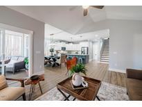 Open-concept living room with modern decor, leading to a spacious kitchen and a screened-in porch at 749 Bowden Rd, Chapel Hill, NC 27516