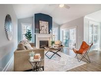 Bright living room boasts fireplace, modern decor, and access to outdoor living area at 749 Bowden Rd, Chapel Hill, NC 27516