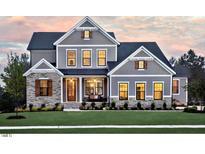Charming two-story home with gray siding, stone accents, well-manicured lawn, and inviting front porch at 0 Lyla'S Ln, Efland, NC 27243