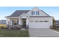 Charming single-Gathering home featuring stone accents, a two-car garage, and a well-manicured front lawn at 113 Seneca Dr # 759, Louisburg, NC 27549