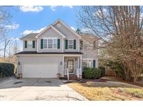 Charming two-story home with gray siding, green shutters, manicured lawn, and inviting front entrance at 1218 Twelve Oaks Ln, Apex, NC 27502