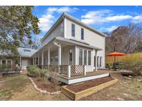 Charming two-story home features a wide porch, well-manicured lawn, deck, and outdoor seating at 206 Spring Ln, Chapel Hill, NC 27514