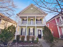 Charming two-story home featuring a quaint front porch and light green siding at 25 Scotch Bonnet Rdg, Clayton, NC 27520