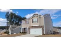 Charming two-story home with stone accents, attached two-car garage, and manicured lawn at 2725 Spring Valley Dr, Creedmoor, NC 27522