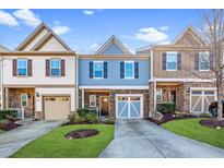 Charming townhouse with stone accents, well-manicured lawn, and attached garages at 304 Presenteer Trl, Apex, NC 27539