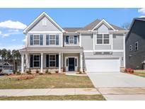 Charming two-story home with gray siding, stone accents, and a well-manicured front yard at 322 N Maple Walk Walk # 237, Garner, NC 27529