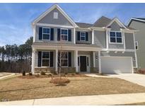 Beautiful two-story home with gray siding, black shutters, and a well-manicured lawn at 322 N Maple Walk Walk # 237, Garner, NC 27529