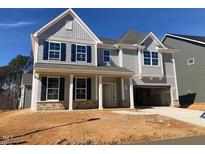 New construction two-story home with gray siding, black shutters, and an attached garage at 322 N Maple Walk Walk # 237, Garner, NC 27529