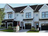 Beautiful new townhomes feature modern design with a white and black color scheme and attached garages at 4093 Elk Crk Ln, Raleigh, NC 27612