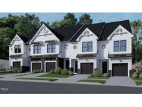 Charming townhomes with white siding, black accents, garage, and landscaping at 4095 Elk Crk Ln, Raleigh, NC 27612