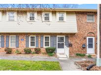 Charming brick townhome with blue shutters, tidy landscaping, and a welcoming entrance at 627 W Front St # C, Burlington, NC 27215